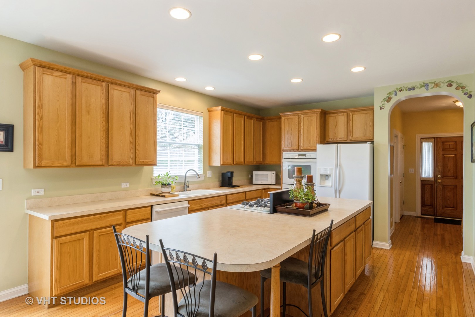 210 Bridle Path Lane Fox River Grove, IL 60021 - Photo 7 of 17 a kitchen with stainless steel appliances granite countertop a stove a sink a refrigerator white cabinets and wooden floor