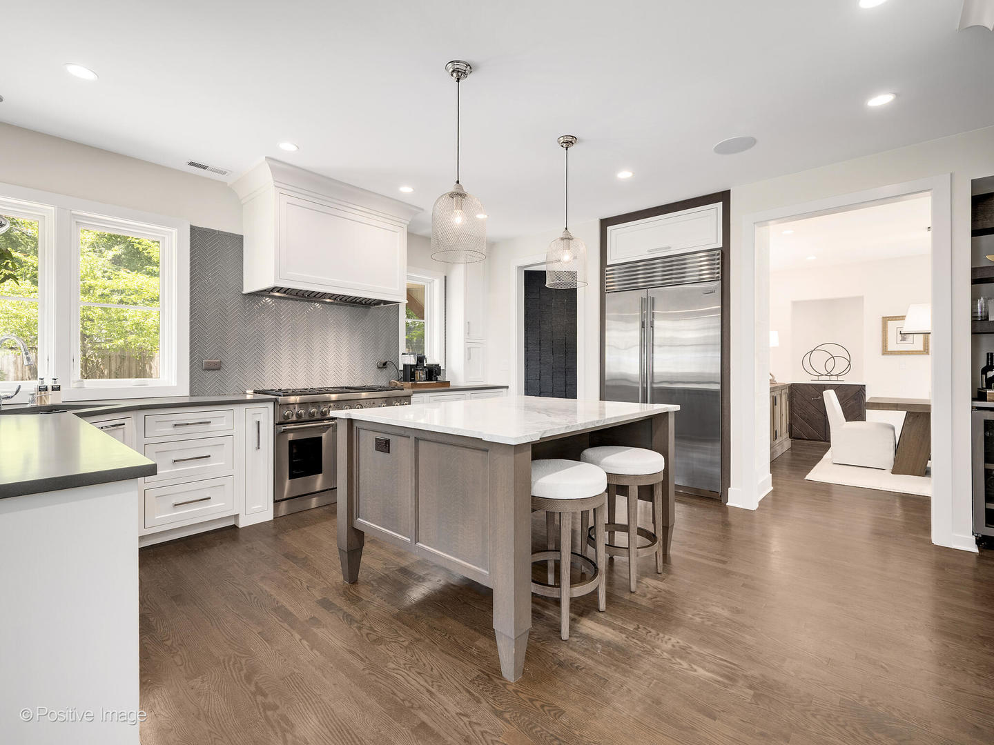 300 Forest Road Hinsdale, IL 60521 - Photo 11 of 43 a kitchen with stainless steel appliances kitchen island granite countertop a table chairs sink and cabinets