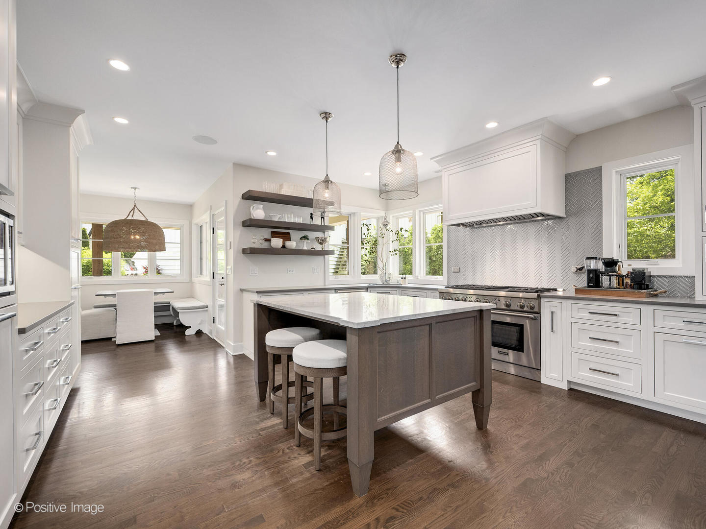 300 Forest Road Hinsdale, IL 60521 - Photo 12 of 43 a kitchen with stainless steel appliances kitchen island granite countertop a stove a sink and a refrigerator