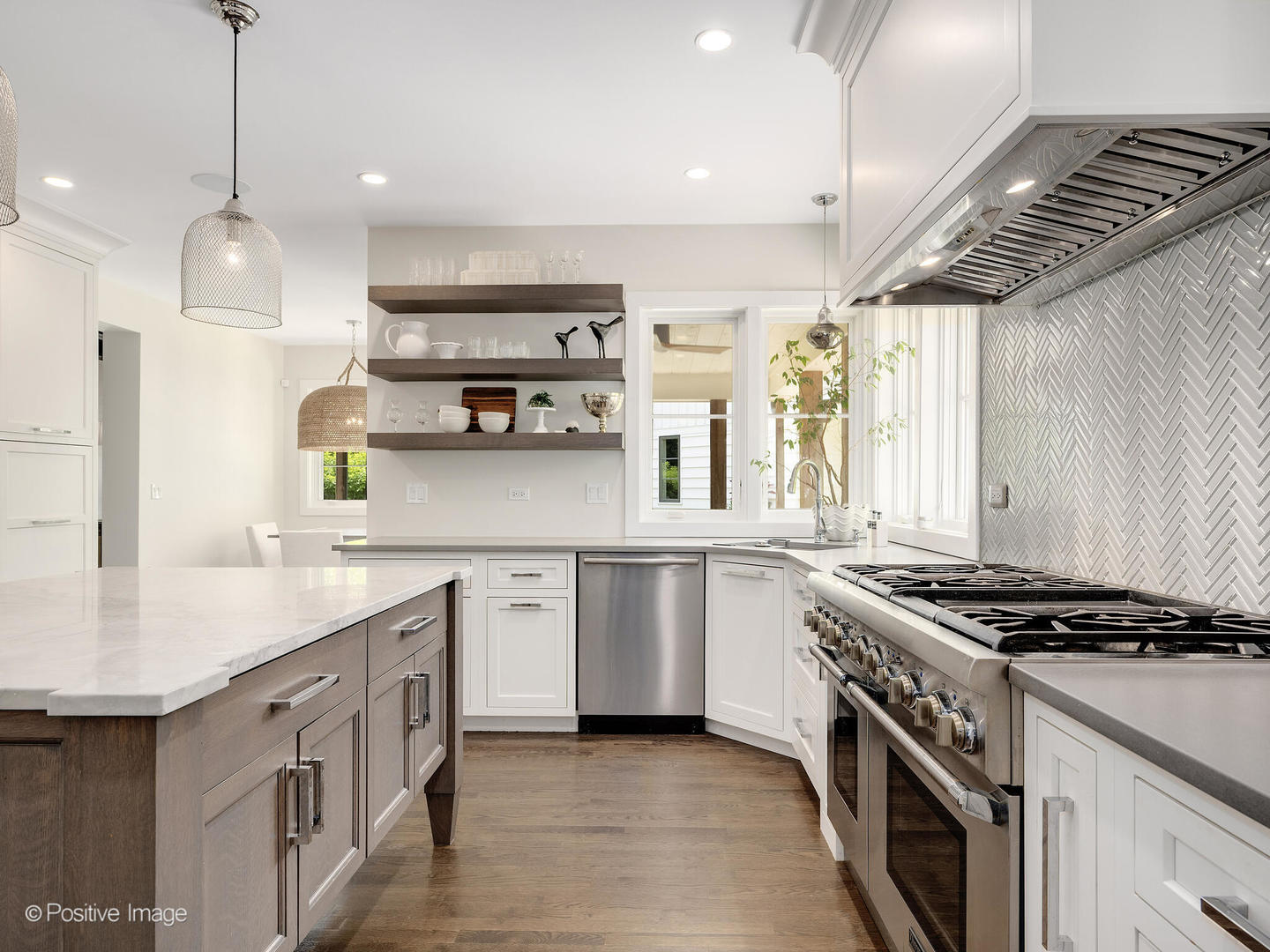 300 Forest Road Hinsdale, IL 60521 - Photo 14 of 43 a kitchen with stainless steel appliances a sink a stove cabinets and a window