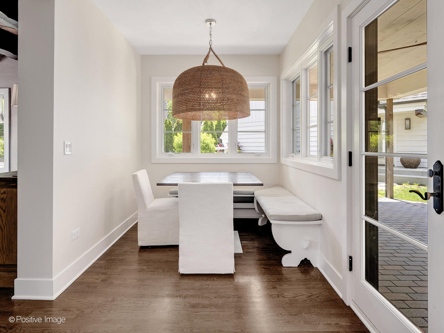 300 Forest Road Hinsdale, IL 60521 - Photo 16 of 43 a hallway with couches and a dining table with wooden floor