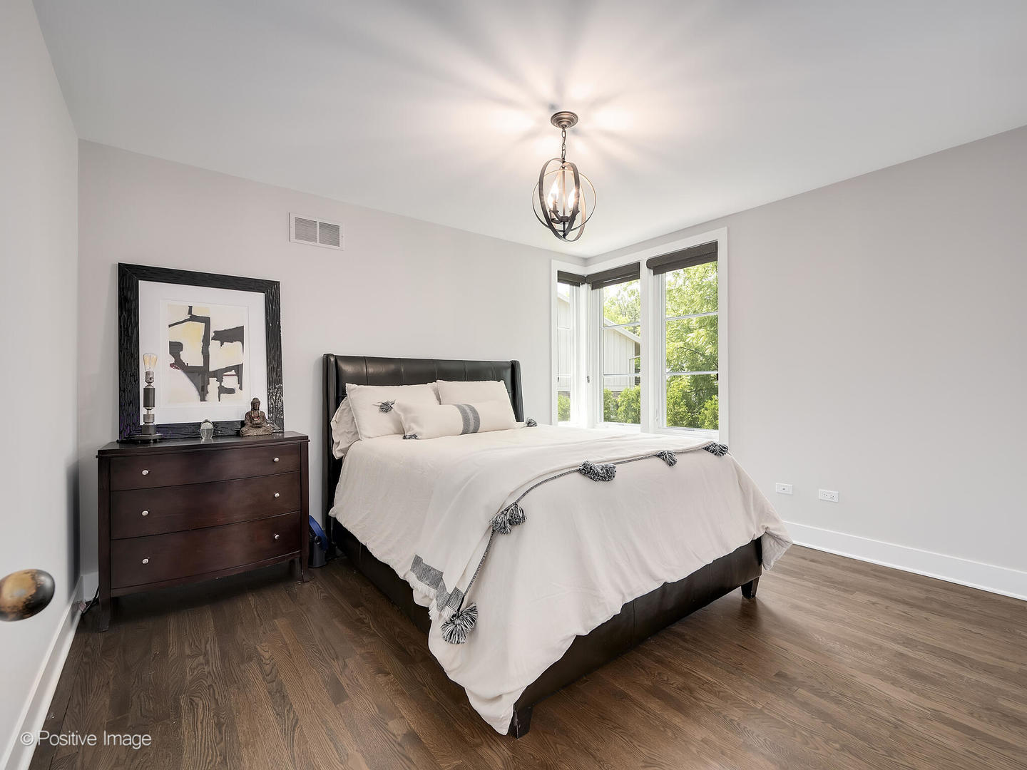 300 Forest Road Hinsdale, IL 60521 - Photo 27 of 43 a bedroom with a bed and a chandelier