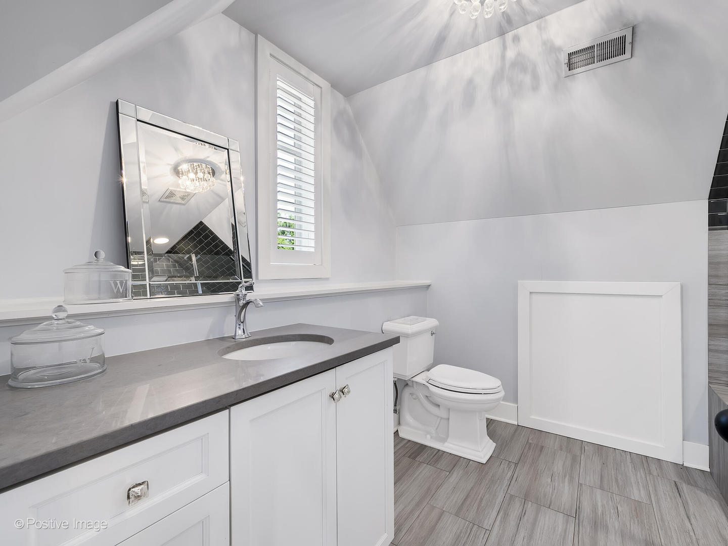 300 Forest Road Hinsdale, IL 60521 - Photo 29 of 43 a bathroom with a granite countertop toilet a sink and a mirror