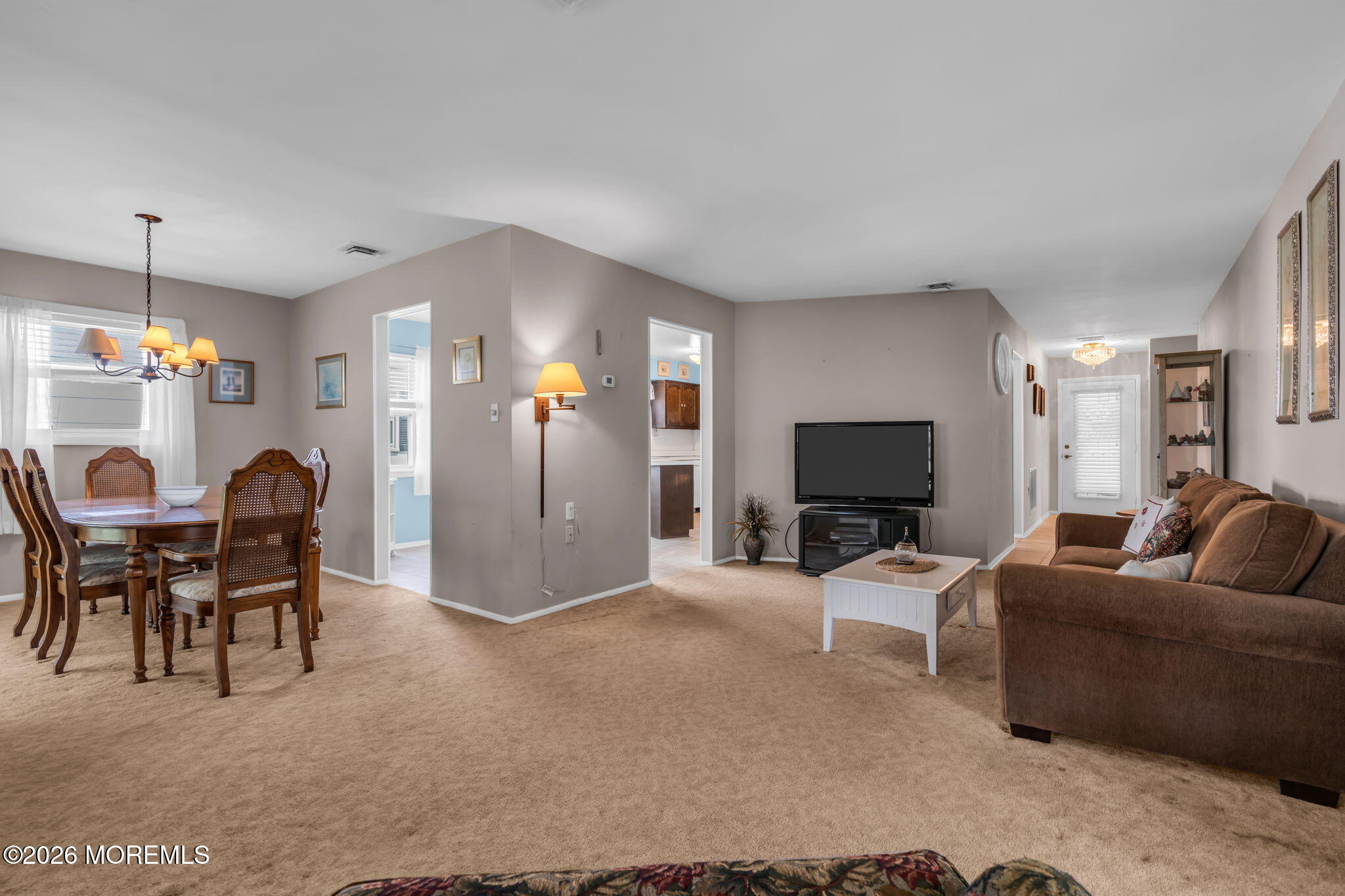 67 Blake Circle Brick, NJ 08724 - Photo 12 of 34 a living room with furniture a dining table and a fireplace