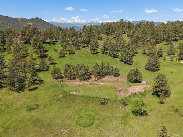a living room with furniture a flat screen tv and kitchen view
