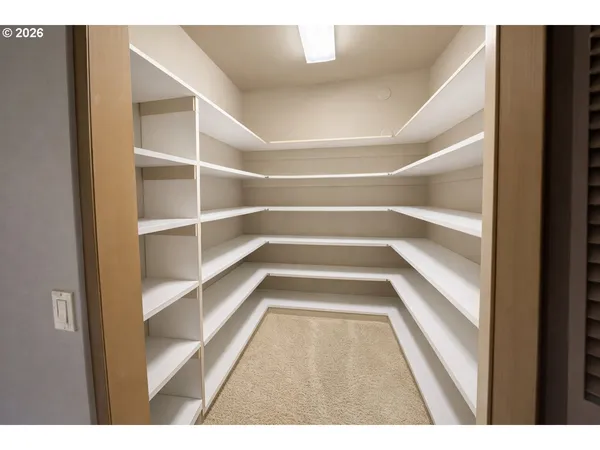 a view of a living room with clothes and a window