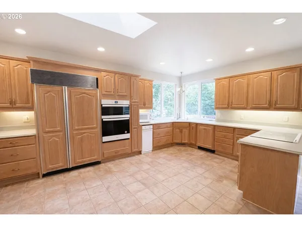 a kitchen with stainless steel appliances a refrigerator and a sink