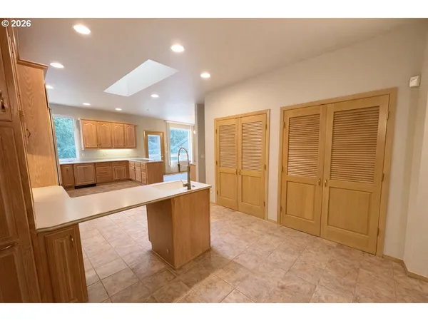 a living room with stainless steel appliances kitchen island furniture and a kitchen view