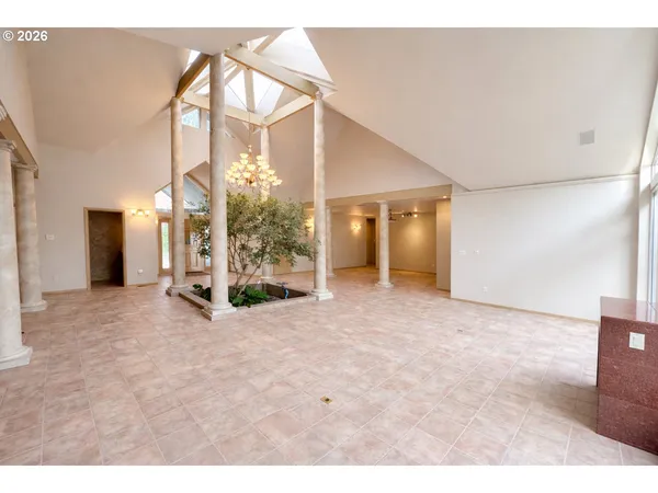 a view of a big room with chandelier and windows