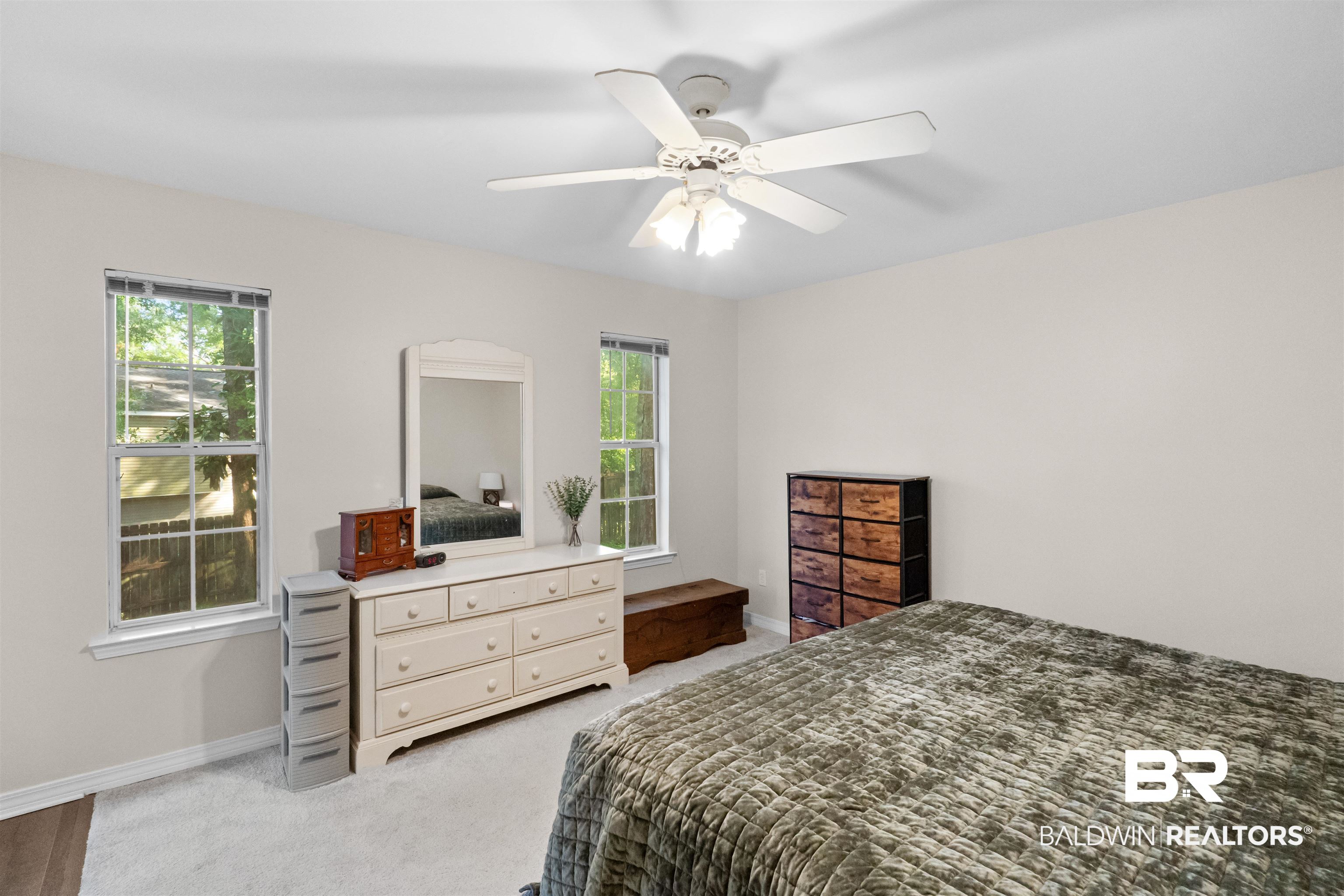 153 Lakeview Loop Daphne, AL 36526 - Photo 30 of 56 Generous proportions and a calming atmosphere make the primary bedroom a comfortable escape at the end of the day.