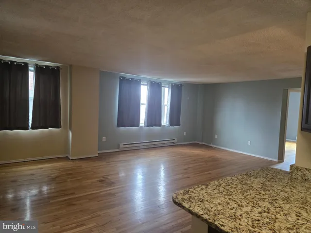 a view of an empty room and wooden floor