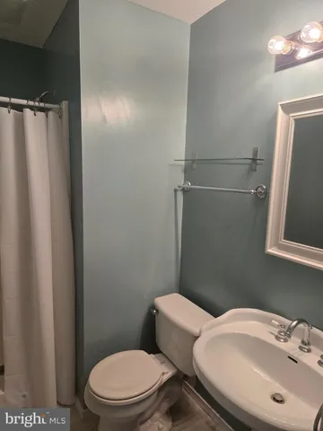 a white toilet sitting next to a bathroom sink