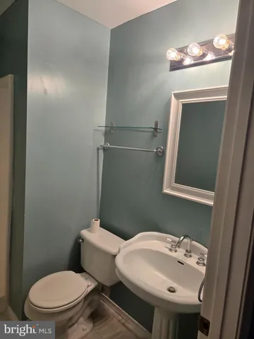 a white toilet sitting next to a bathroom sink