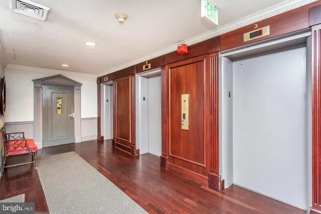 a view of a hallway with closet and wooden floor