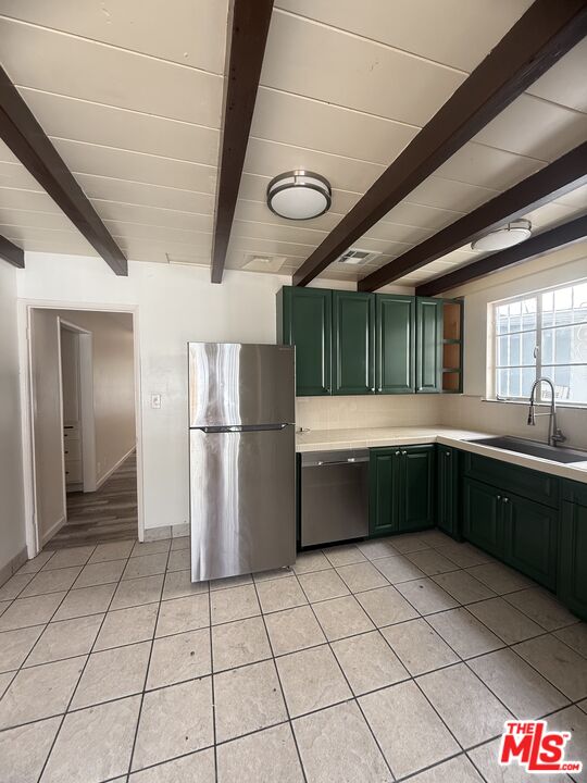 12015 Riverside Drive Valley Village, CA 91607 - Photo 8 of 12 a kitchen with stainless steel appliances granite countertop a refrigerator and a sink