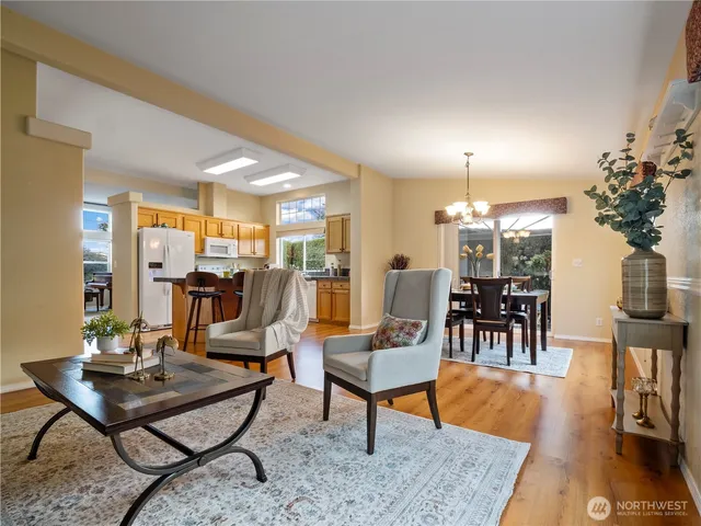 a living room with furniture and a dining table
