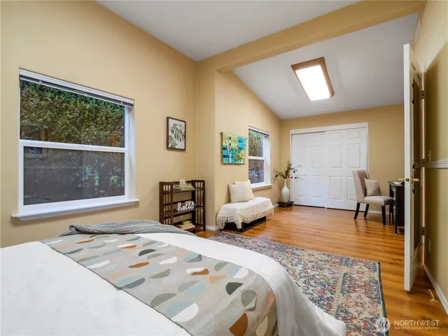 a bedroom with a bed couch and a window