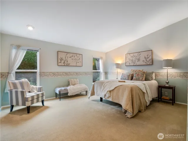 a spacious bedroom with a bed and a couch