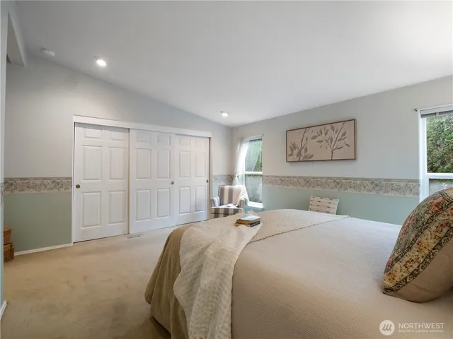 a bedroom with a bed and a painting