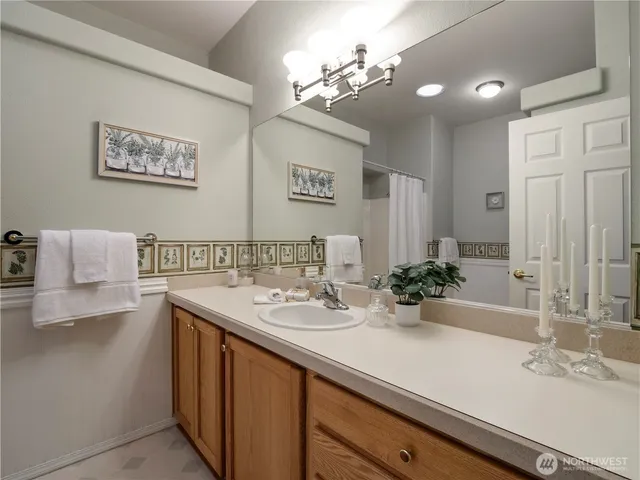 a bathroom with a sink a large mirror and vanity