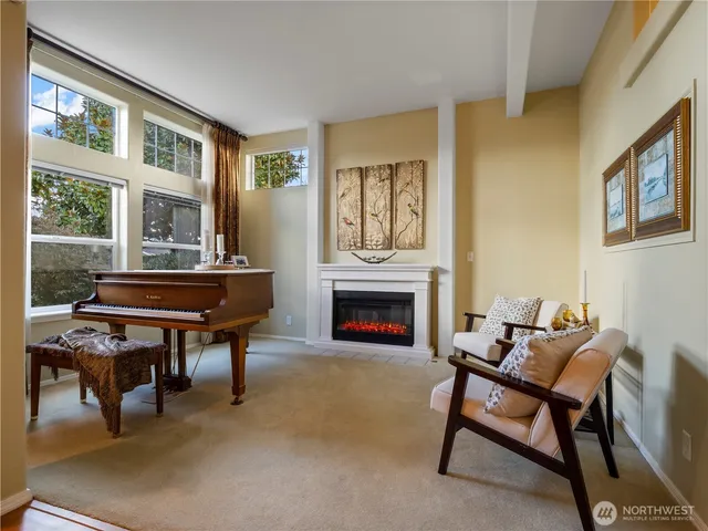 a living room with furniture a fireplace and a table