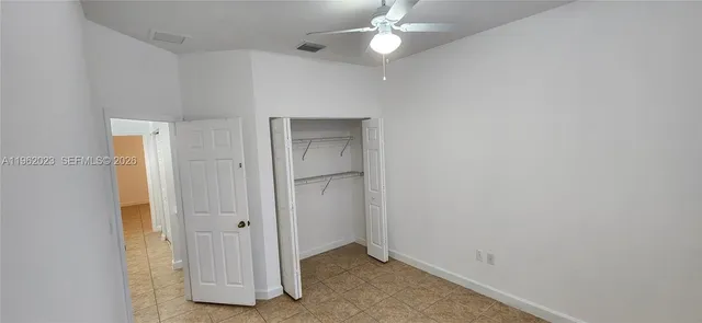 a white toilet sitting next to a bathroom sink and a shower curtain