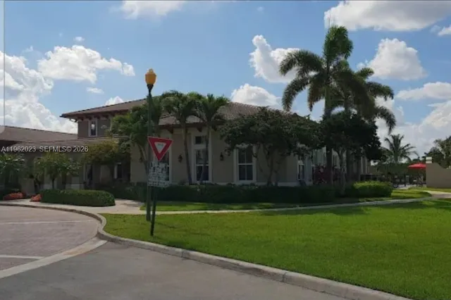 a view of a house with a yard balcony and sitting area