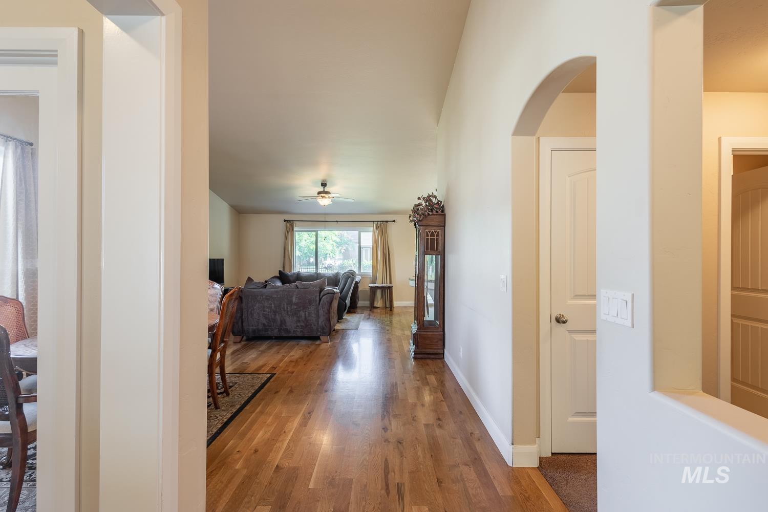 1186 East Observation Street Meridian, ID 83642 - Photo 8 of 33 Open concept living space featuring wood-finish flooring, vaulted ceilings, and a ceiling fan