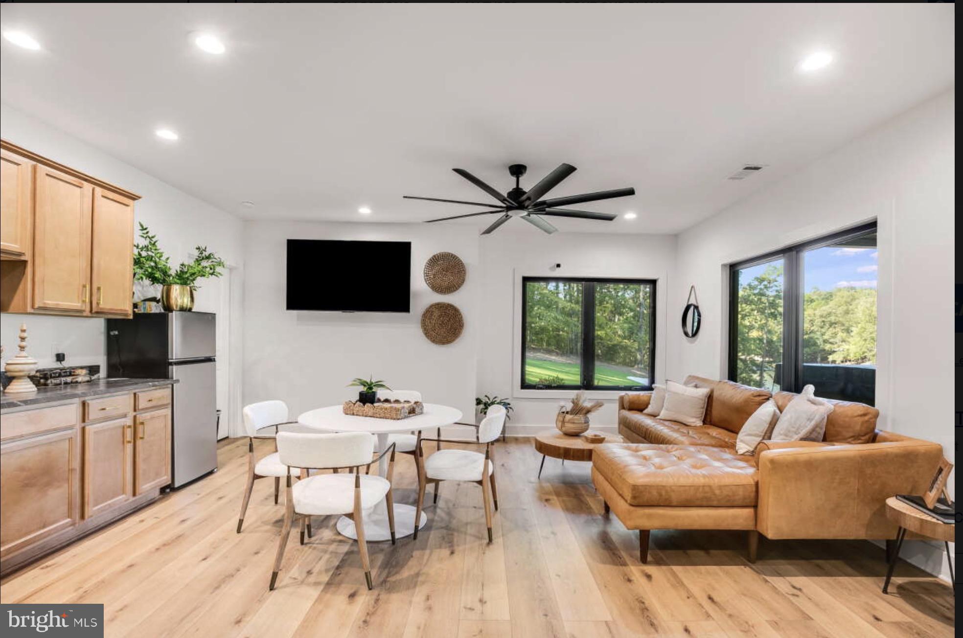 1440 Drummer Hill Road Front Royal, VA 22630 - Photo 52 of 58 a living room with furniture a flat screen tv and a large window