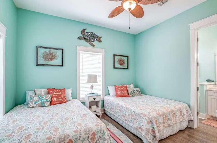 922 Palm Ridge Drive Crystal Beach, TX 77650 - Photo 11 of 17 a bedroom with a bed and a chandelier