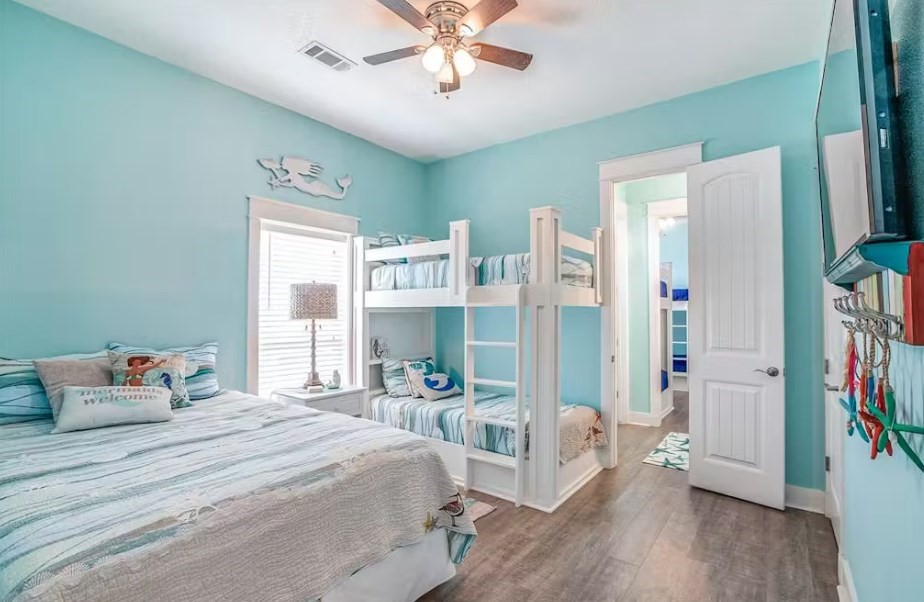 922 Palm Ridge Drive Crystal Beach, TX 77650 - Photo 13 of 17 a bedroom with furniture and a large window