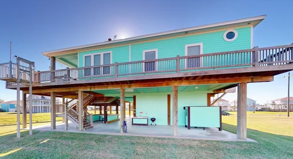922 Palm Ridge Drive Crystal Beach, TX 77650 - Photo 15 of 17 a front view of a house with swimming pool having outdoor seating