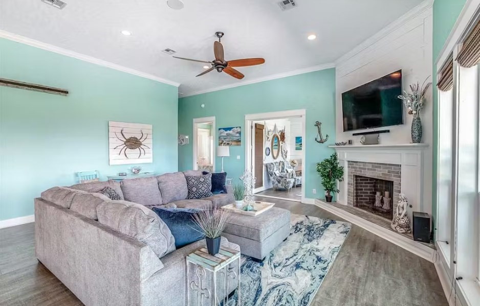 922 Palm Ridge Drive Crystal Beach, TX 77650 - Photo 2 of 17 a living room with furniture a fireplace and a flat screen tv