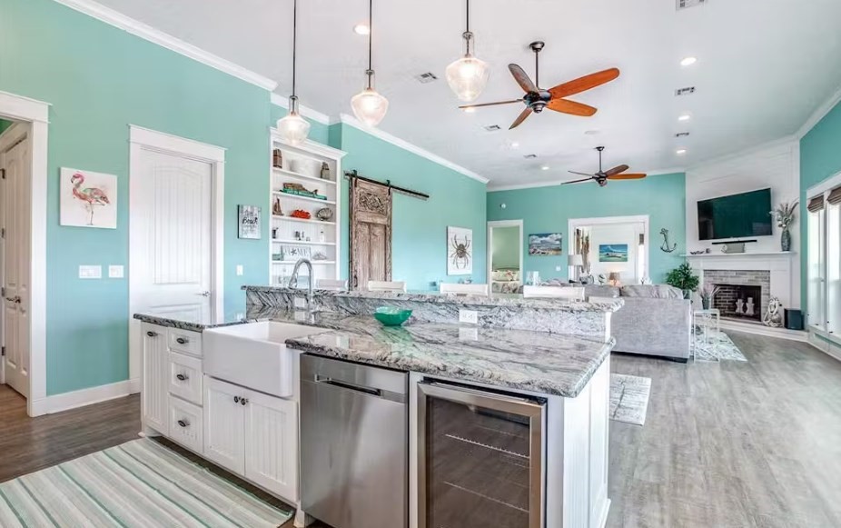 922 Palm Ridge Drive Crystal Beach, TX 77650 - Photo 4 of 17 a kitchen with a counter space a sink appliances and a ceiling fan