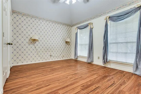 a bathroom with a toilet a sink a mirror a bathtub and vanity