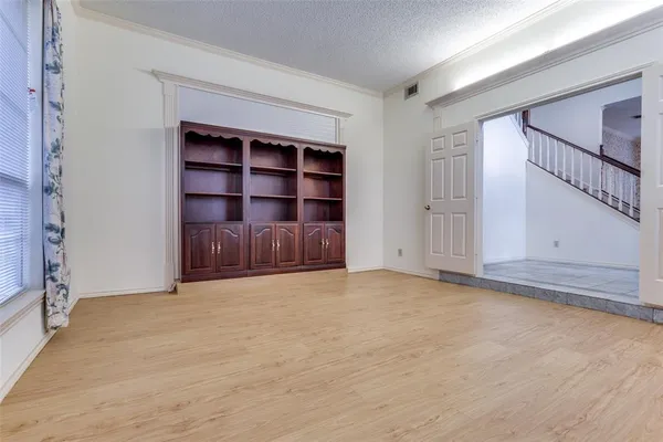 wooden floor in an empty room with a fireplace