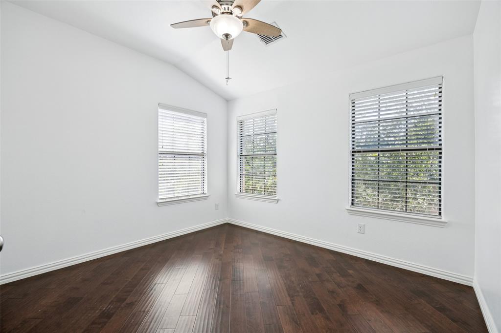1503 Biltmore Lane Irving, TX 75063 - Photo 15 of 34 a view of an empty room with wooden floor and a window