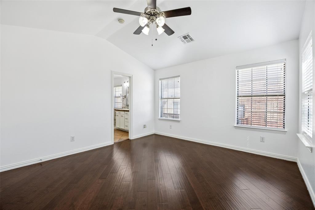 1503 Biltmore Lane Irving, TX 75063 - Photo 18 of 34 an empty room with wooden floor chandelier fan and windows