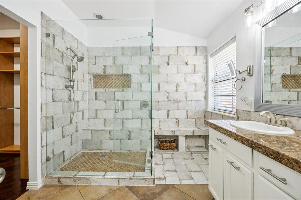 1503 Biltmore Lane Irving, TX 75063 - Photo 21 of 34 a bathroom with a granite countertop sink a mirror and shower
