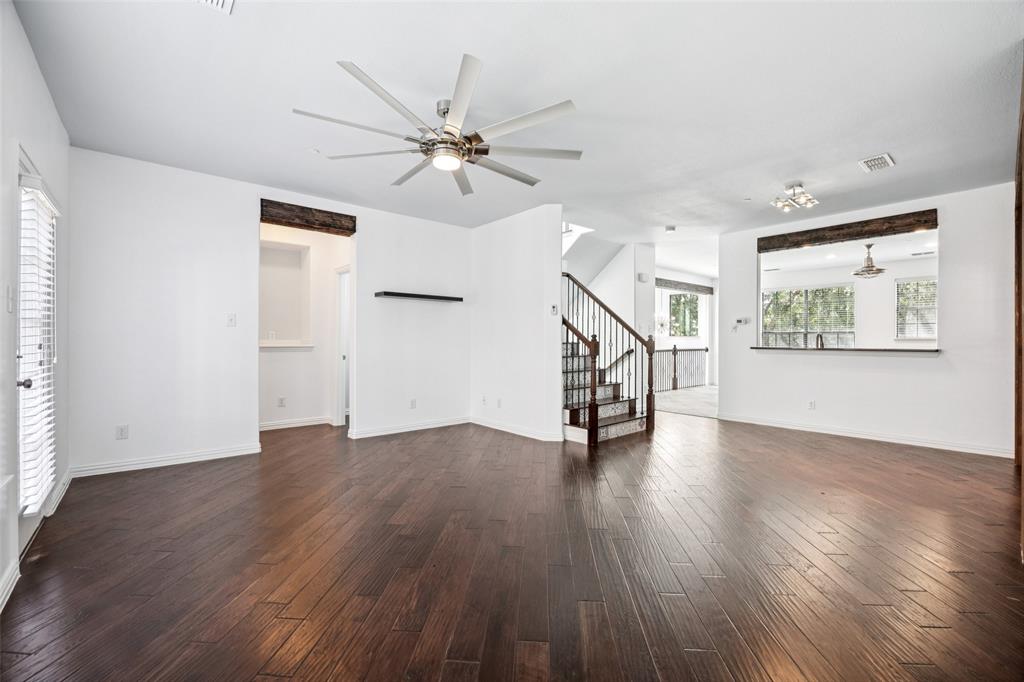 1503 Biltmore Lane Irving, TX 75063 - Photo 24 of 34 an empty room with wooden floor fan and windows