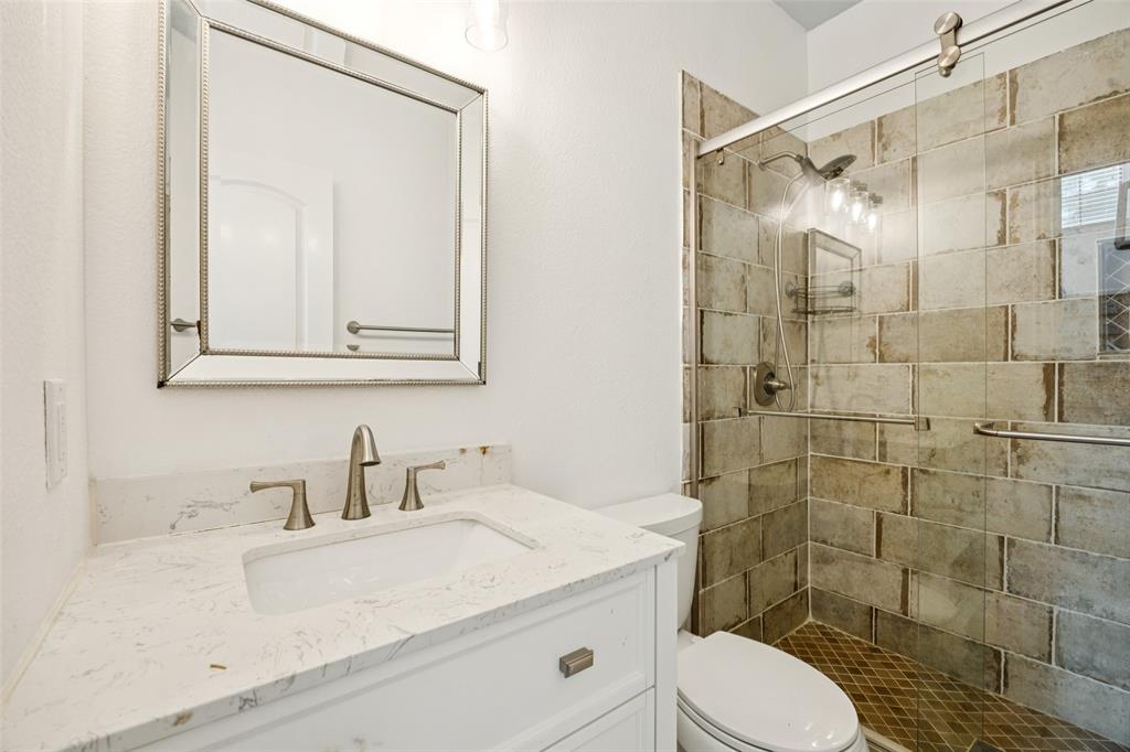1503 Biltmore Lane Irving, TX 75063 - Photo 6 of 34 a bathroom with a sink toilet and shower