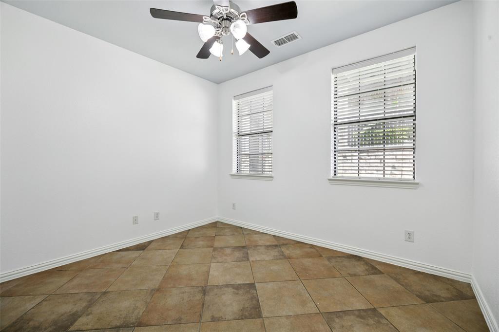 1503 Biltmore Lane Irving, TX 75063 - Photo 7 of 34 an empty room with windows and fan