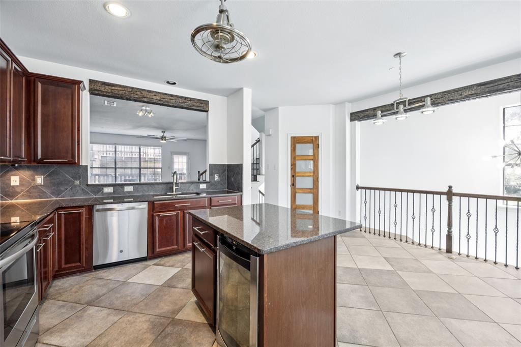 1503 Biltmore Lane Irving, TX 75063 - Photo 10 of 34 a kitchen with stainless steel appliances granite countertop a stove and a sink
