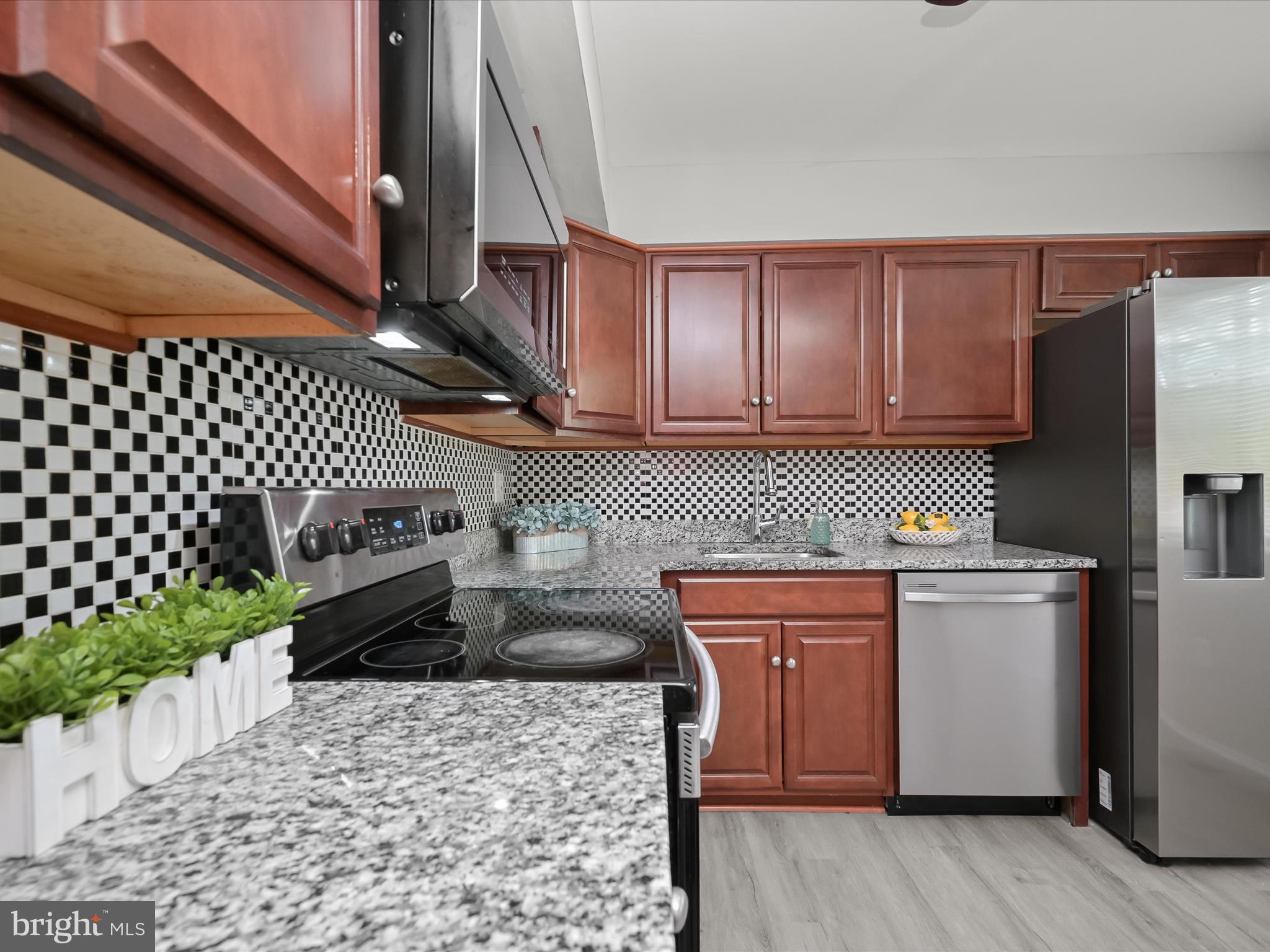 7106 Winter Rose Path Columbia, MD 21045 - Photo 10 of 50 a kitchen with a stove a sink and a refrigerator