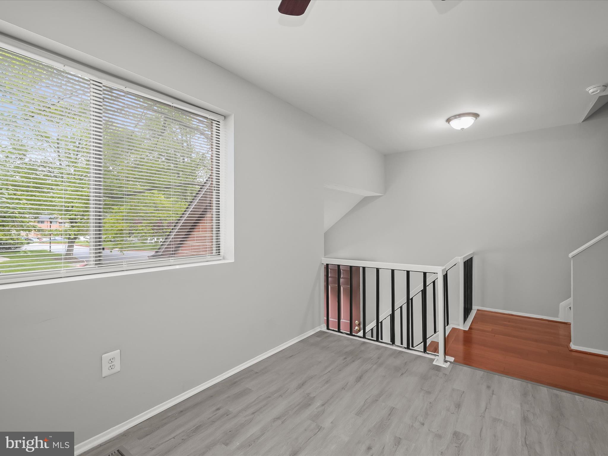 7106 Winter Rose Path Columbia, MD 21045 - Photo 11 of 50 a view of a hallway with wooden floor and fan