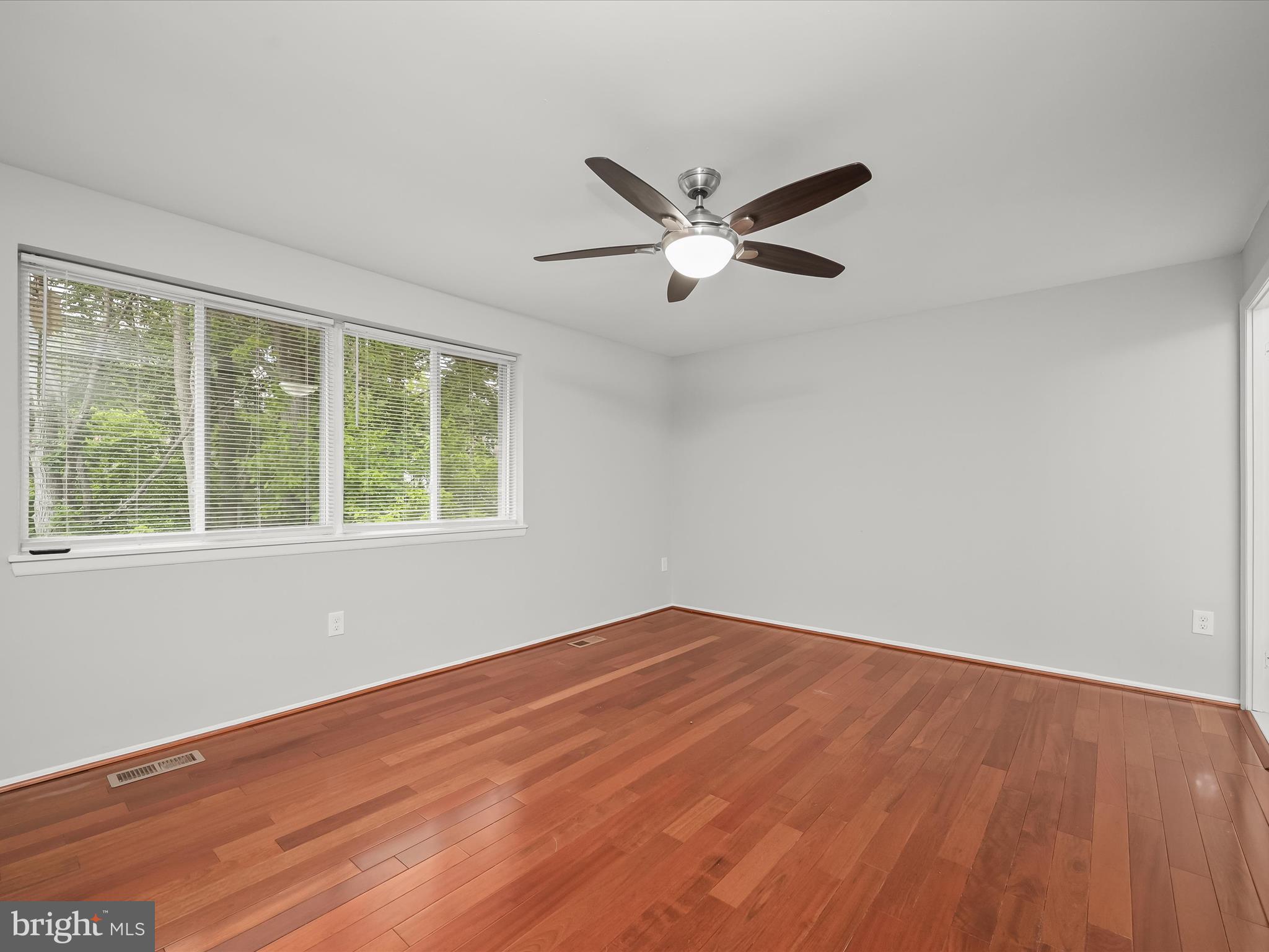 7106 Winter Rose Path Columbia, MD 21045 - Photo 17 of 50 a view of empty room with wooden floor and fan