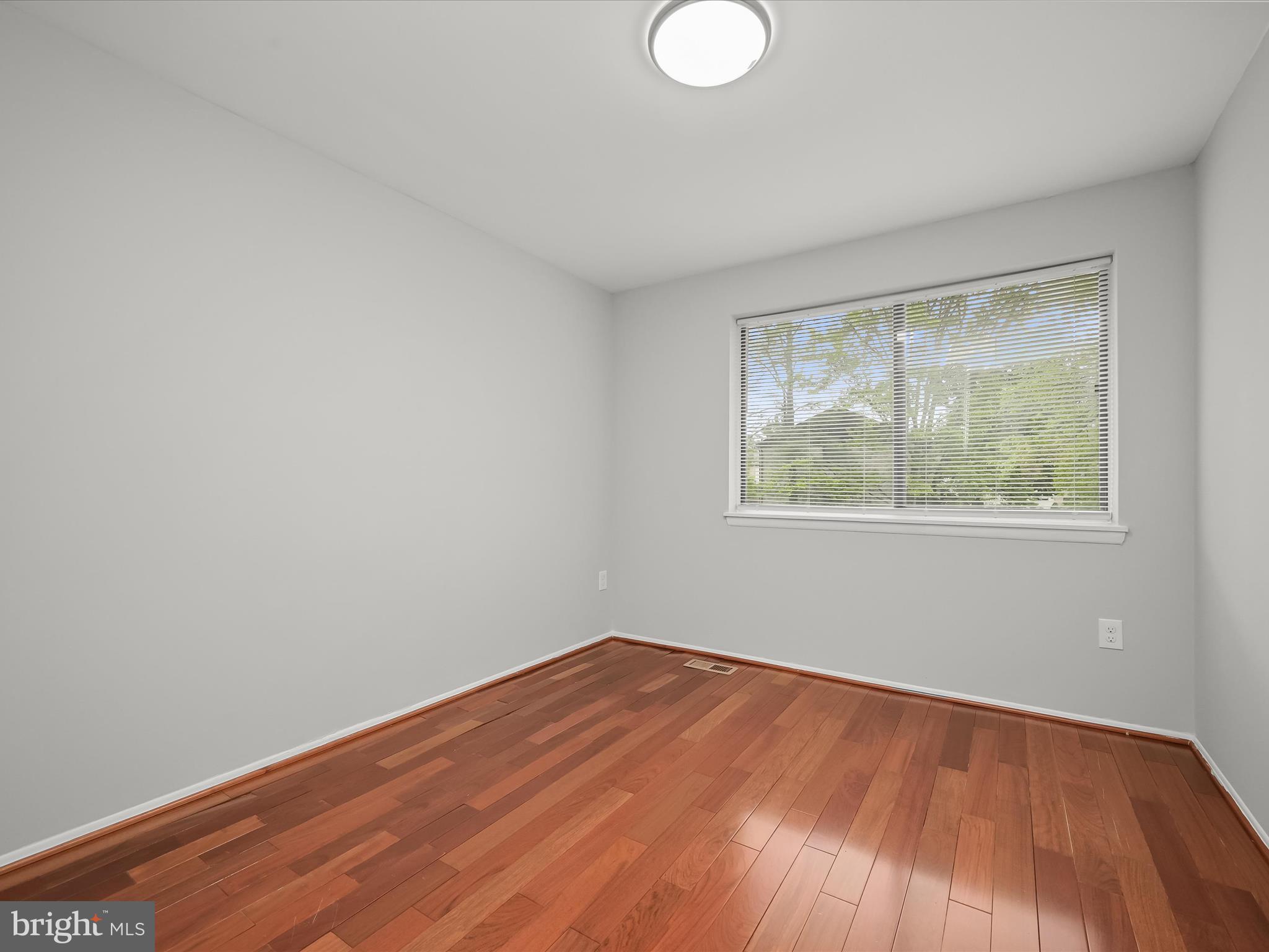 7106 Winter Rose Path Columbia, MD 21045 - Photo 25 of 50 wooden floor in an empty room with a window