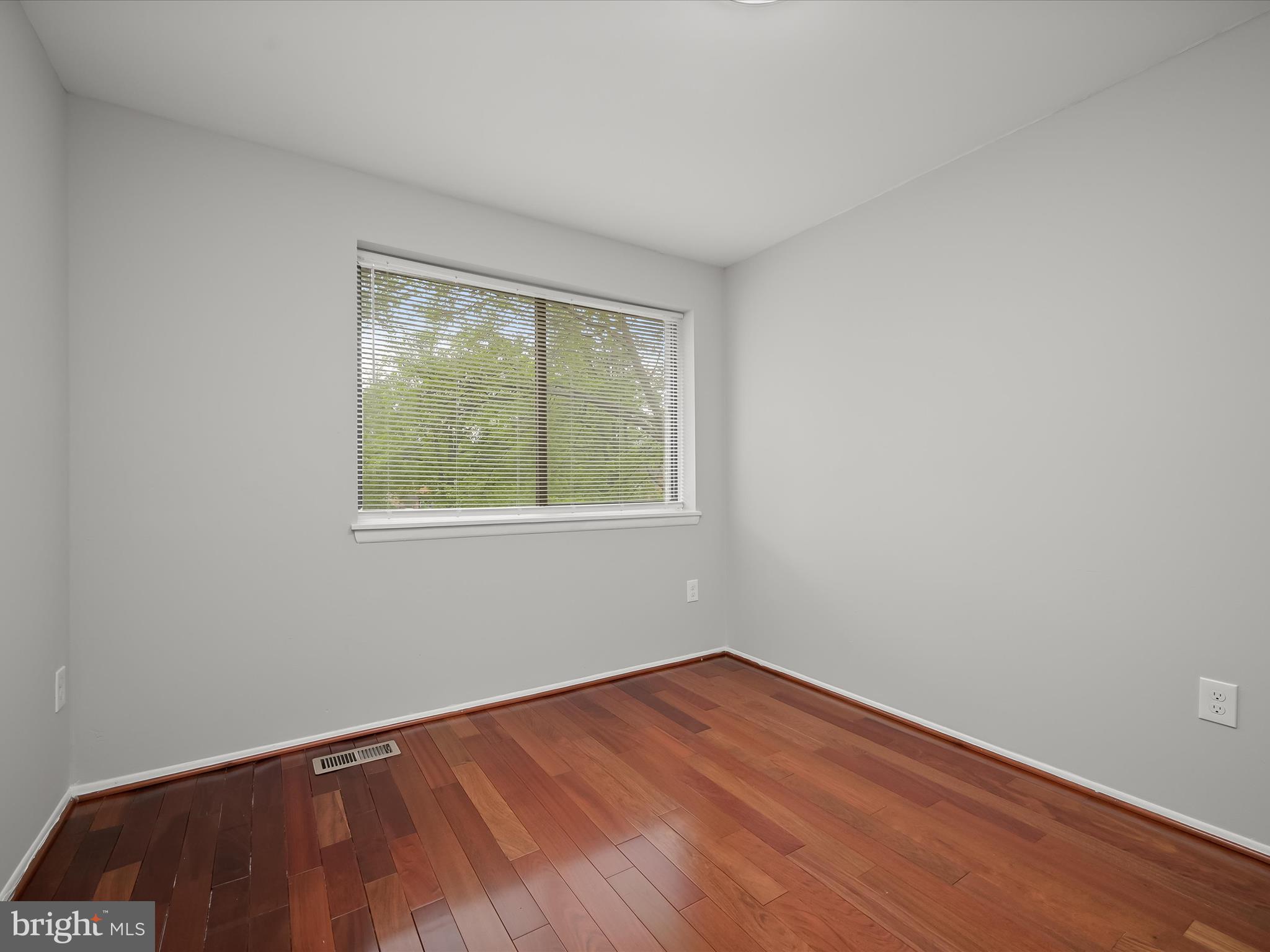 7106 Winter Rose Path Columbia, MD 21045 - Photo 27 of 50 a view of an empty room with wooden floor and a window