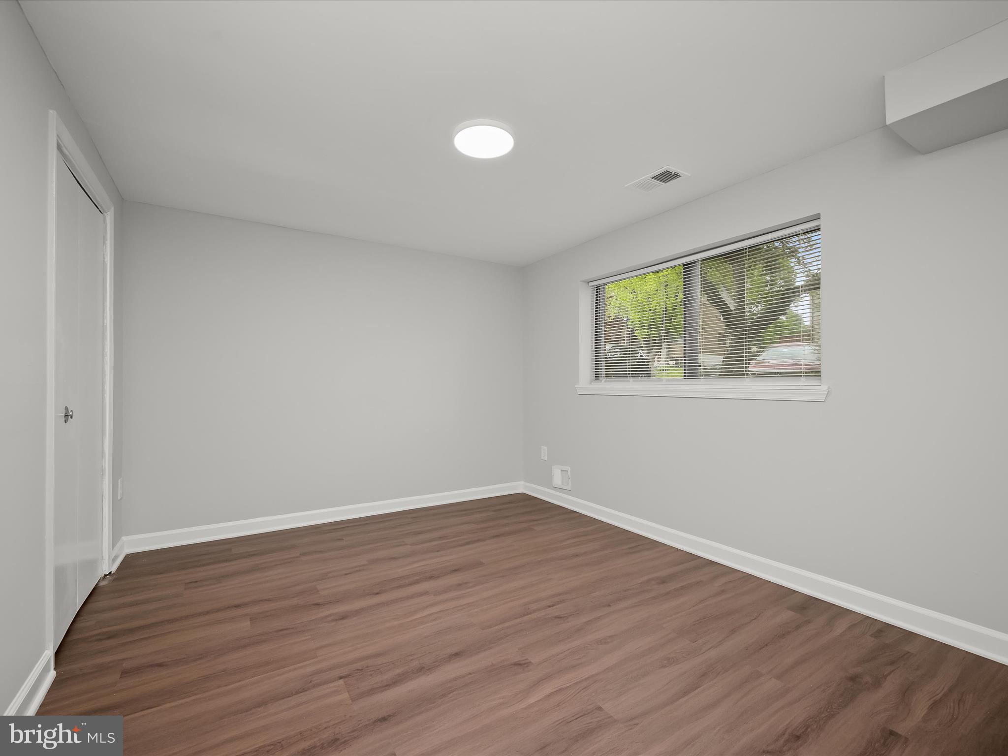 7106 Winter Rose Path Columbia, MD 21045 - Photo 32 of 50 an empty room with wooden floor and windows