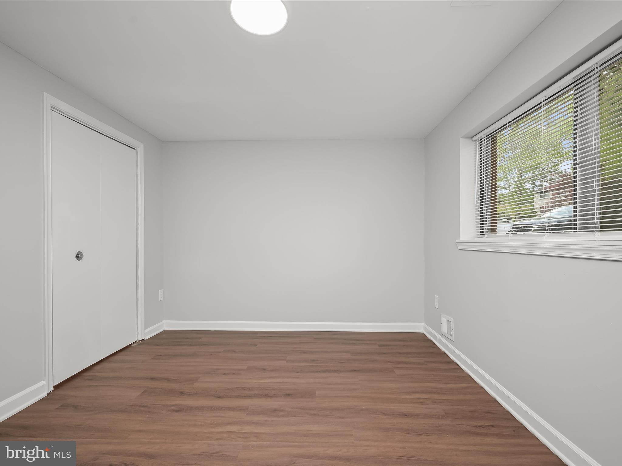 7106 Winter Rose Path Columbia, MD 21045 - Photo 33 of 50 a view of an empty room with wooden floor and a window